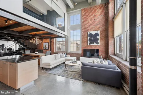 a living room with furniture a fireplace and windows