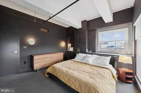 a bedroom with double bed and a large window