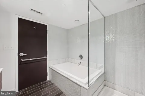a bathroom with a bathtub and a shower