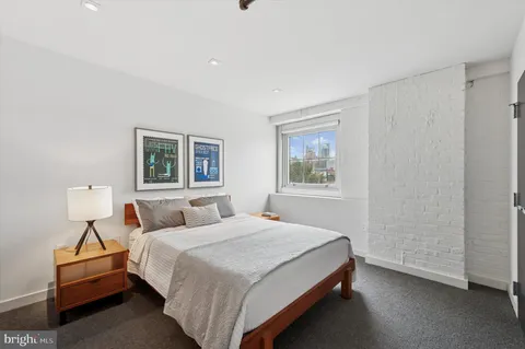 a bedroom with a bed and a night stand