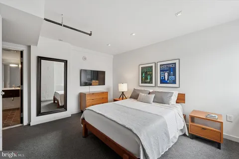 a bedroom with a bed and a couch