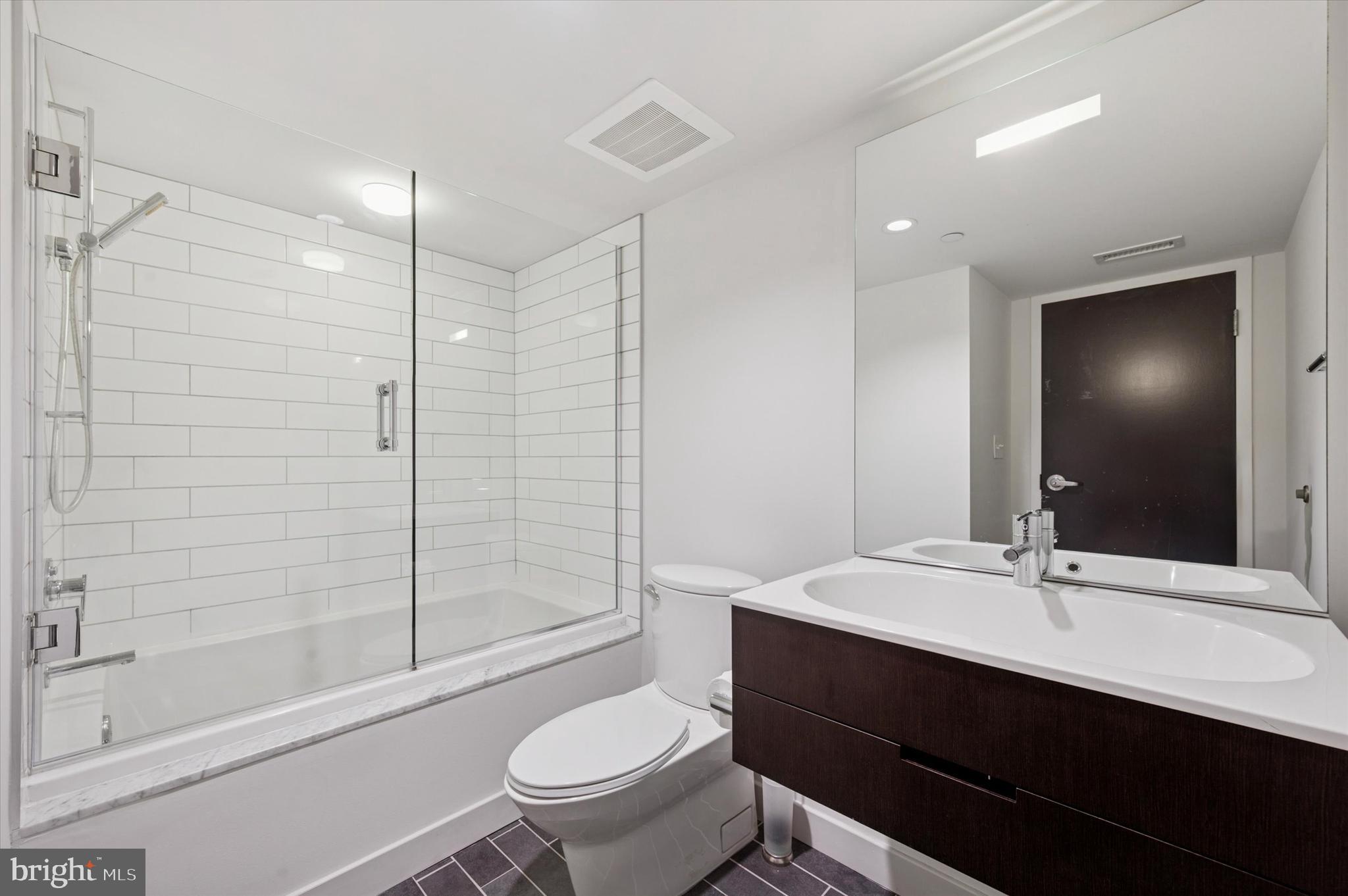 1101 Washington Avenue, Unit 306 Philadelphia, PA 19147 - Photo 22 of 25 a bathroom with a sink a toilet and shower