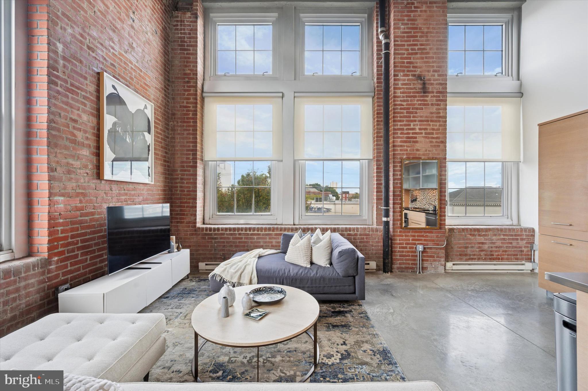1101 Washington Avenue, Unit 306 Philadelphia, PA 19147 - Photo 10 of 25 a living room with furniture and a large window