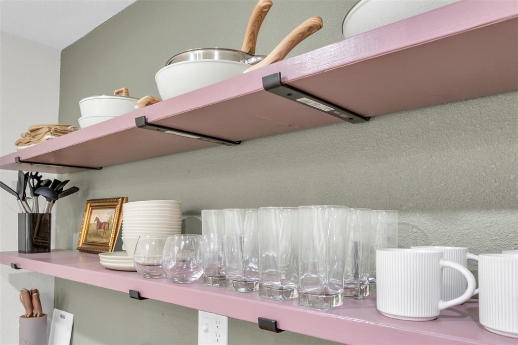 4121 Junius Street, Unit B Dallas, TX 75246 - Photo 27 of 32 Open shelving featuring a light pink finish and contrasting wall paint