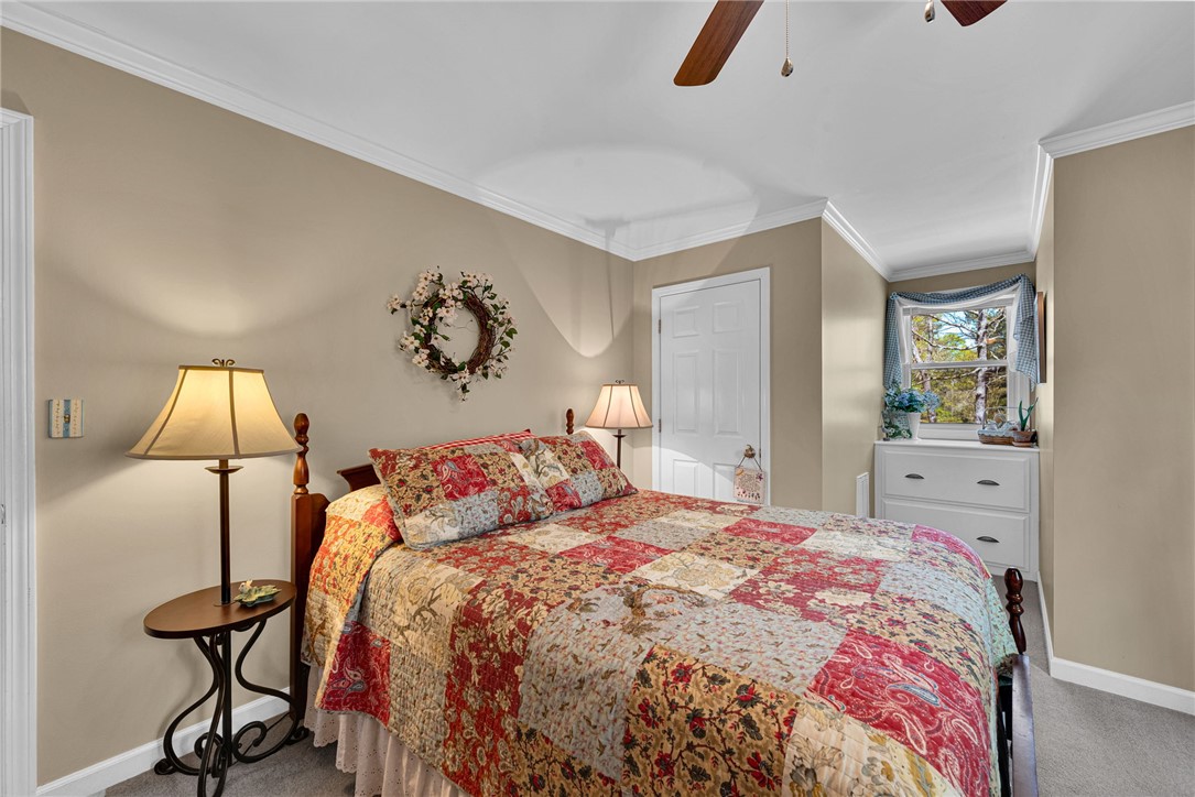 1010 Ridgeview Drive Pendleton, SC 29670 - Photo 32 of 47 This cozy bedroom features a ceiling fan, crown molding, and a charming window nook.
