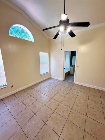 a hallway view with a wooden floor and a bathroom