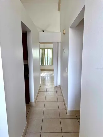 a view of an empty room and a window