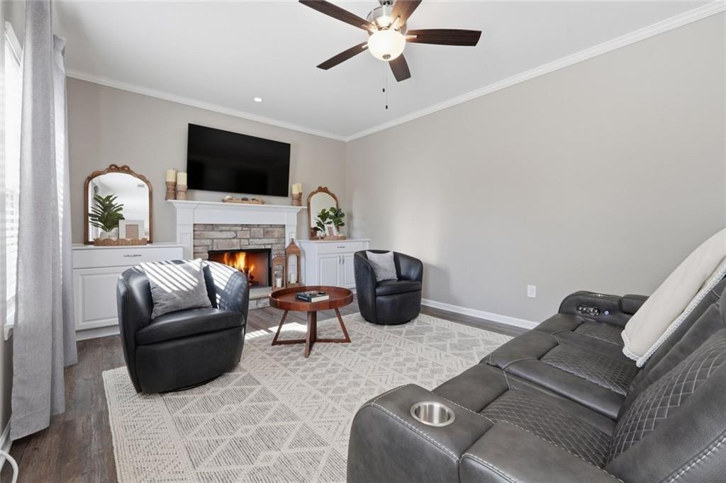 166 Ashbridge Lane Dallas, GA 30132 - Photo 11 of 35 a living room with furniture a flat screen tv and a fireplace
