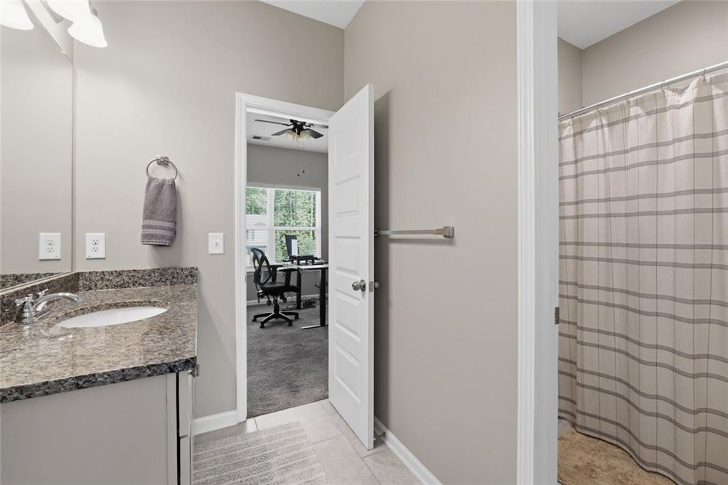 166 Ashbridge Lane Dallas, GA 30132 - Photo 15 of 35 a en suite bathroom with a granite countertop sink and a mirror