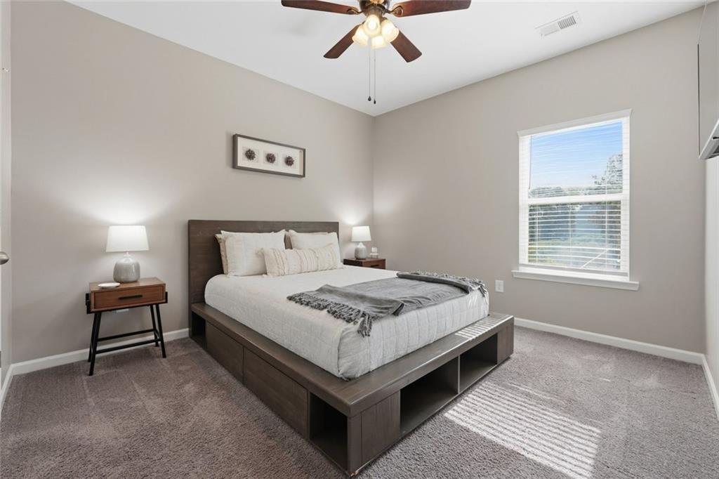 166 Ashbridge Lane Dallas, GA 30132 - Photo 16 of 35 a bed sitting in a bedroom next to a window