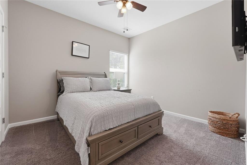 166 Ashbridge Lane Dallas, GA 30132 - Photo 17 of 35 a bed sitting in a bedroom and chandelier