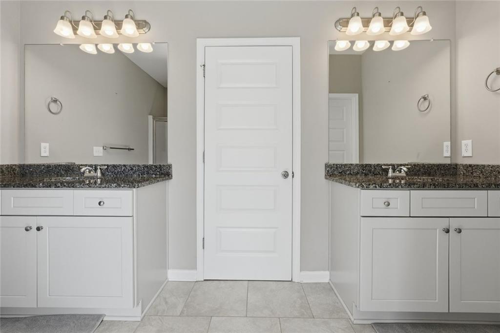 166 Ashbridge Lane Dallas, GA 30132 - Photo 22 of 35 a bathroom with a granite countertop sink and a mirror