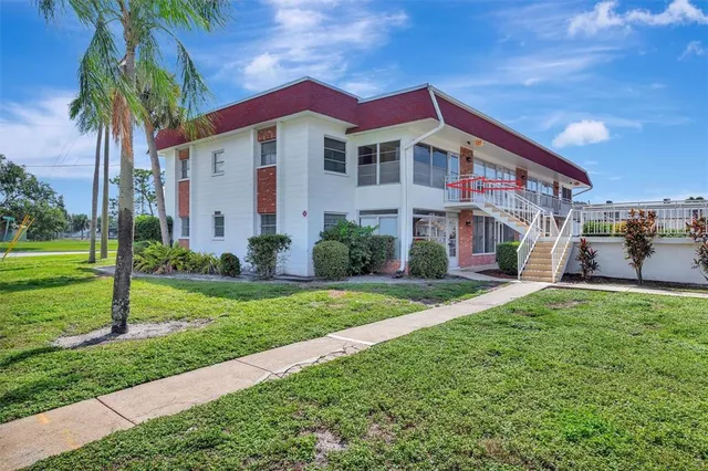 a front view of a house with yard and green space