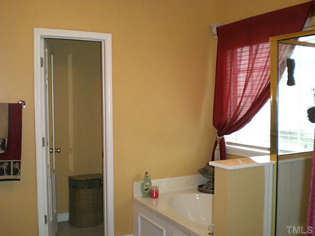 4900 Abbotts Pointe Court Raleigh, NC 27616 - Photo 14 of 25 a bathroom with a sink and a window
