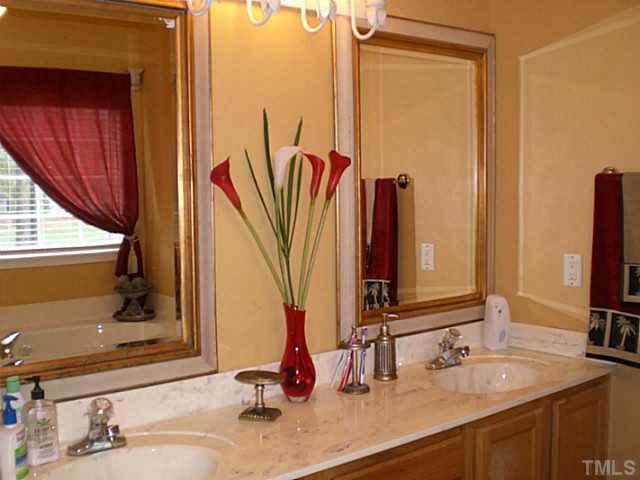 4900 Abbotts Pointe Court Raleigh, NC 27616 - Photo 15 of 25 a bathroom with a double vanity sink and a mirror