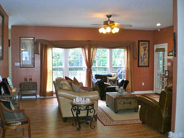 4900 Abbotts Pointe Court Raleigh, NC 27616 - Photo 6 of 25 a living room with furniture and a large window