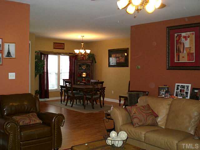 4900 Abbotts Pointe Court Raleigh, NC 27616 - Photo 8 of 25 a living room with furniture and wooden floor