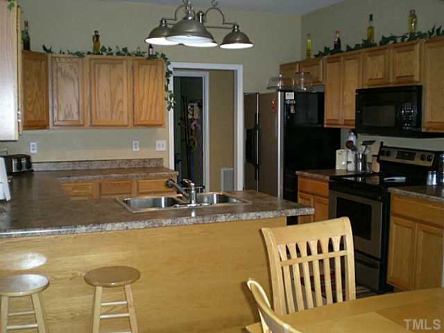 4900 Abbotts Pointe Court Raleigh, NC 27616 - Photo 10 of 25 a kitchen with a sink and a refrigerator