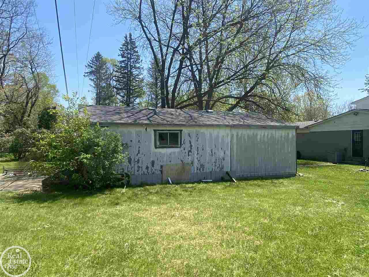 1300 Yule Road Leonard, MI 48367 - Photo 50 of 53 32' x 22' extra garage, needs repair and most of the materials are inside.