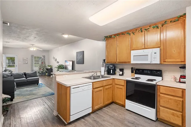a kitchen with a stove a sink and a refrigerator