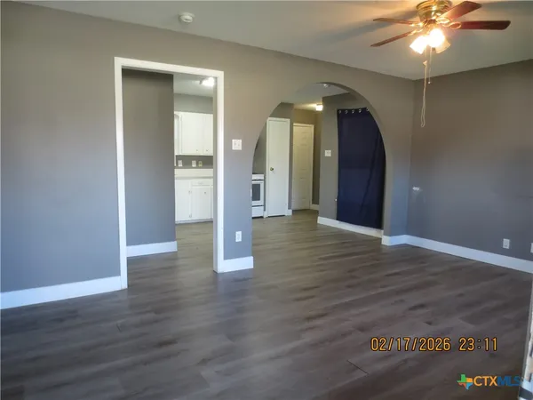 wooden floor in an empty room with a mirror