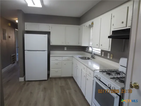 a kitchen with a sink a stove and refrigerator