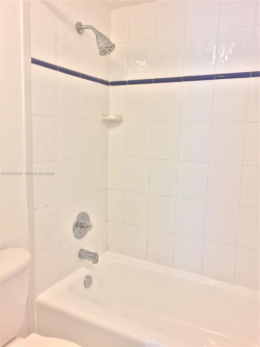 9225 Southwest 87th Avenue, Unit A8 Miami, FL 33176 - Photo 12 of 14 a bathroom with a shower and a bathtub