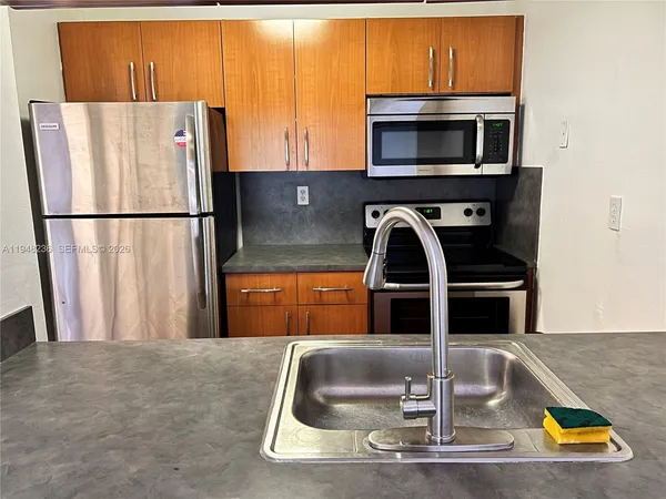 a kitchen with a refrigerator and a sink