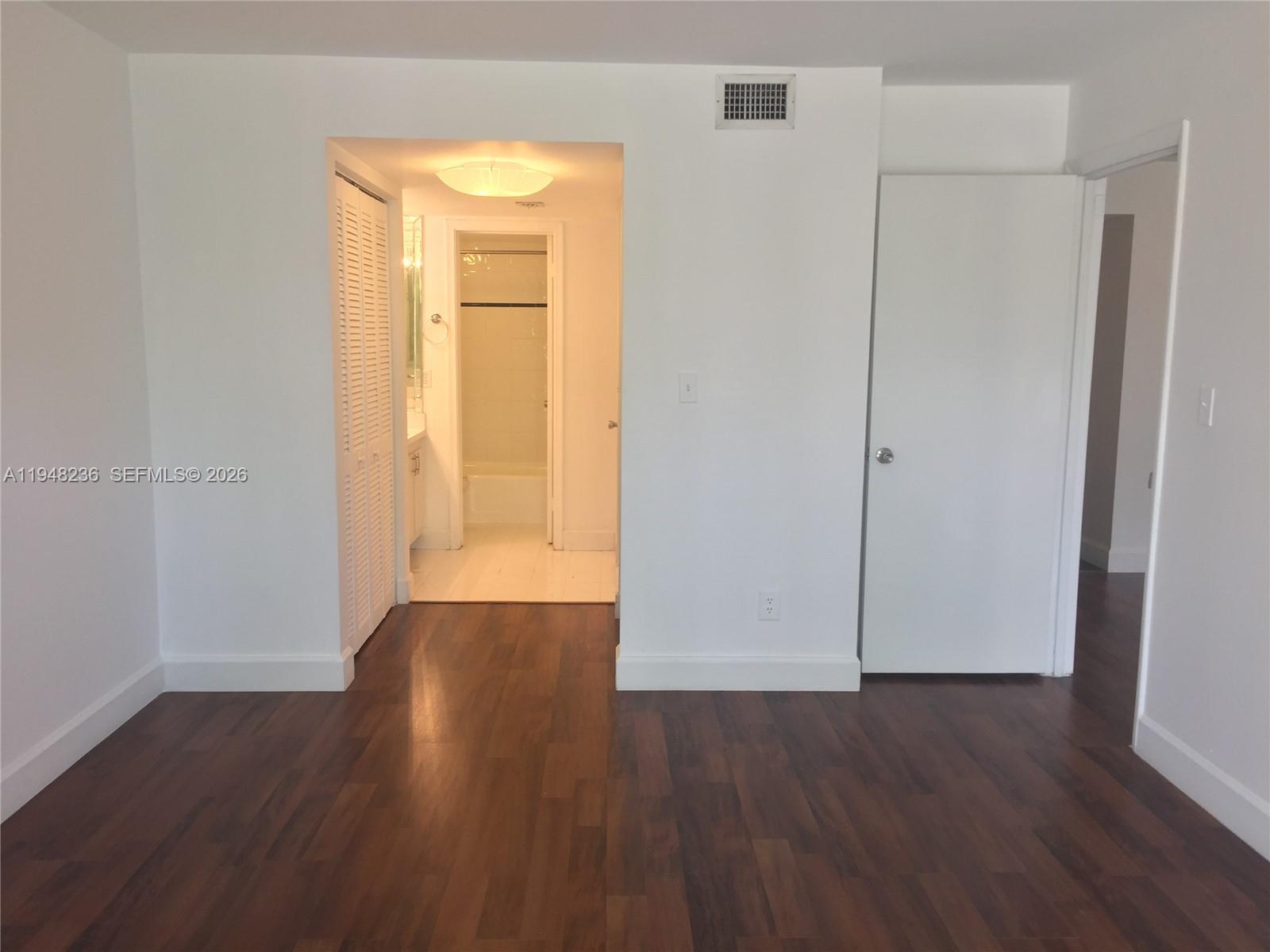 9225 Southwest 87th Avenue, Unit A8 Miami, FL 33176 - Photo 9 of 14 an empty room with wooden floor and closet