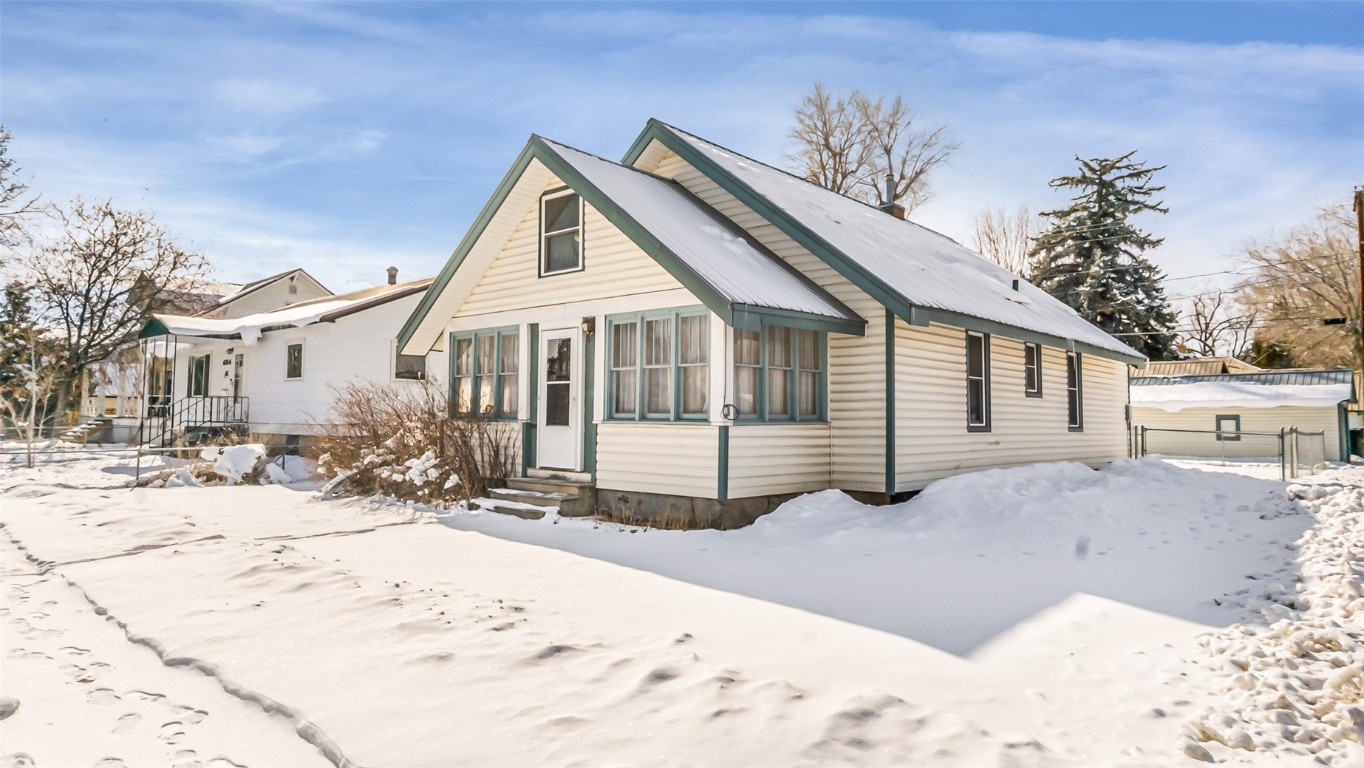 694 Russell Street Craig, CO 81625 - Photo 1 of 40 a view of a house with a yard covered in snow
