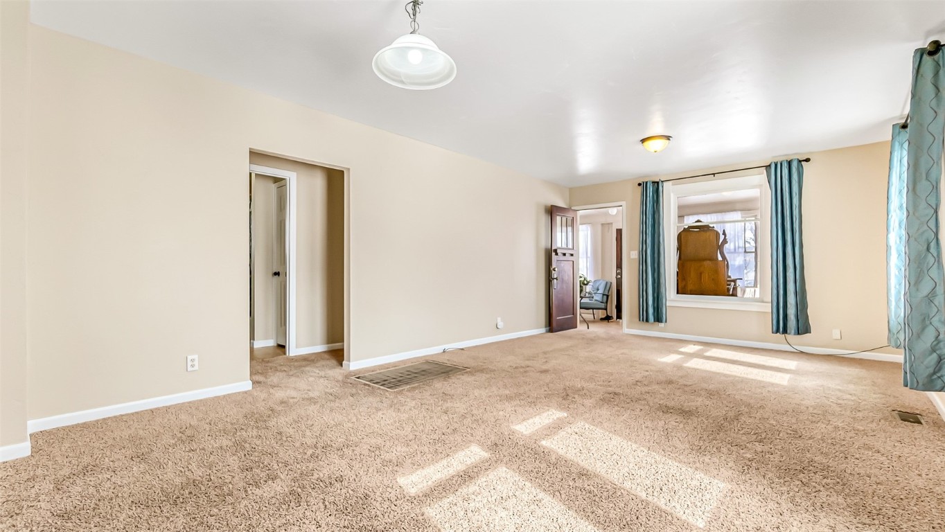 694 Russell Street Craig, CO 81625 - Photo 16 of 40 a view of a hallway with wooden floor and a large window
