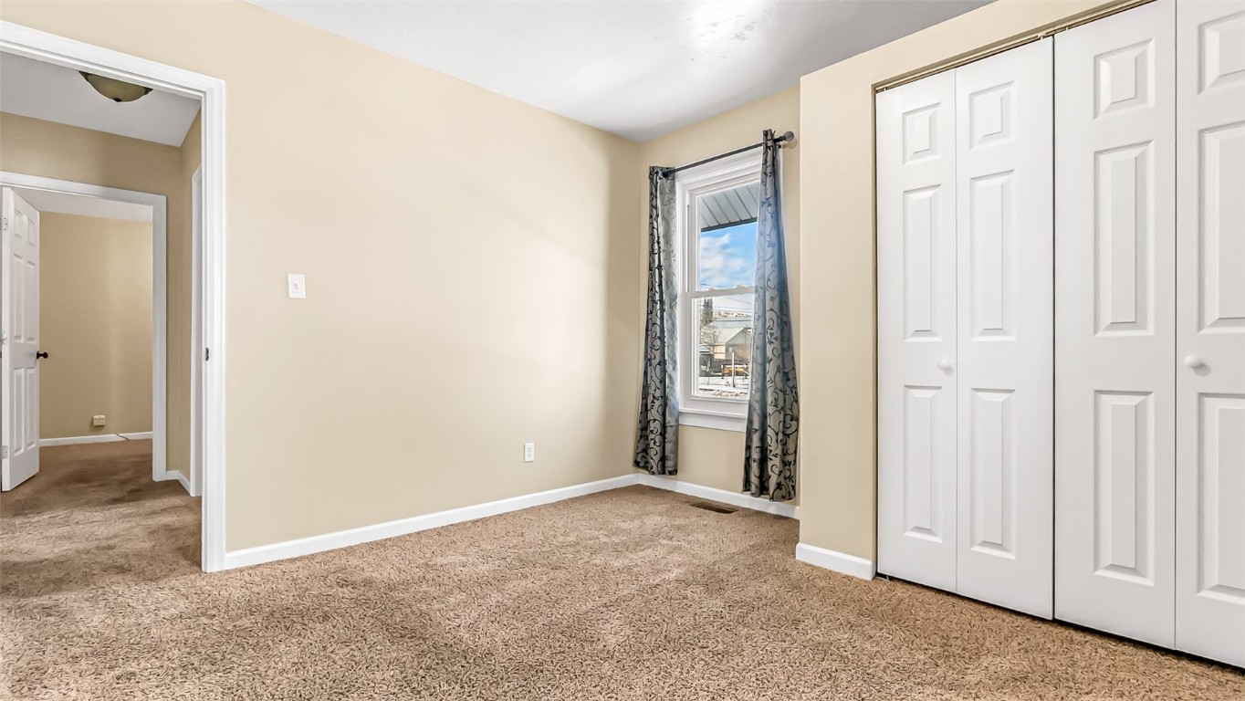 694 Russell Street Craig, CO 81625 - Photo 6 of 40 an empty room with windows and closet