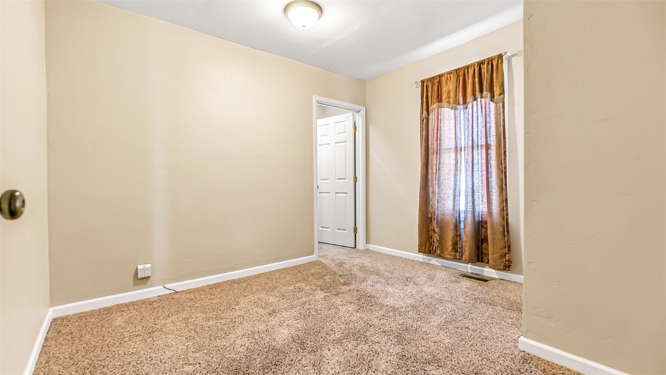 694 Russell Street Craig, CO 81625 - Photo 8 of 40 an empty room with windows and closet