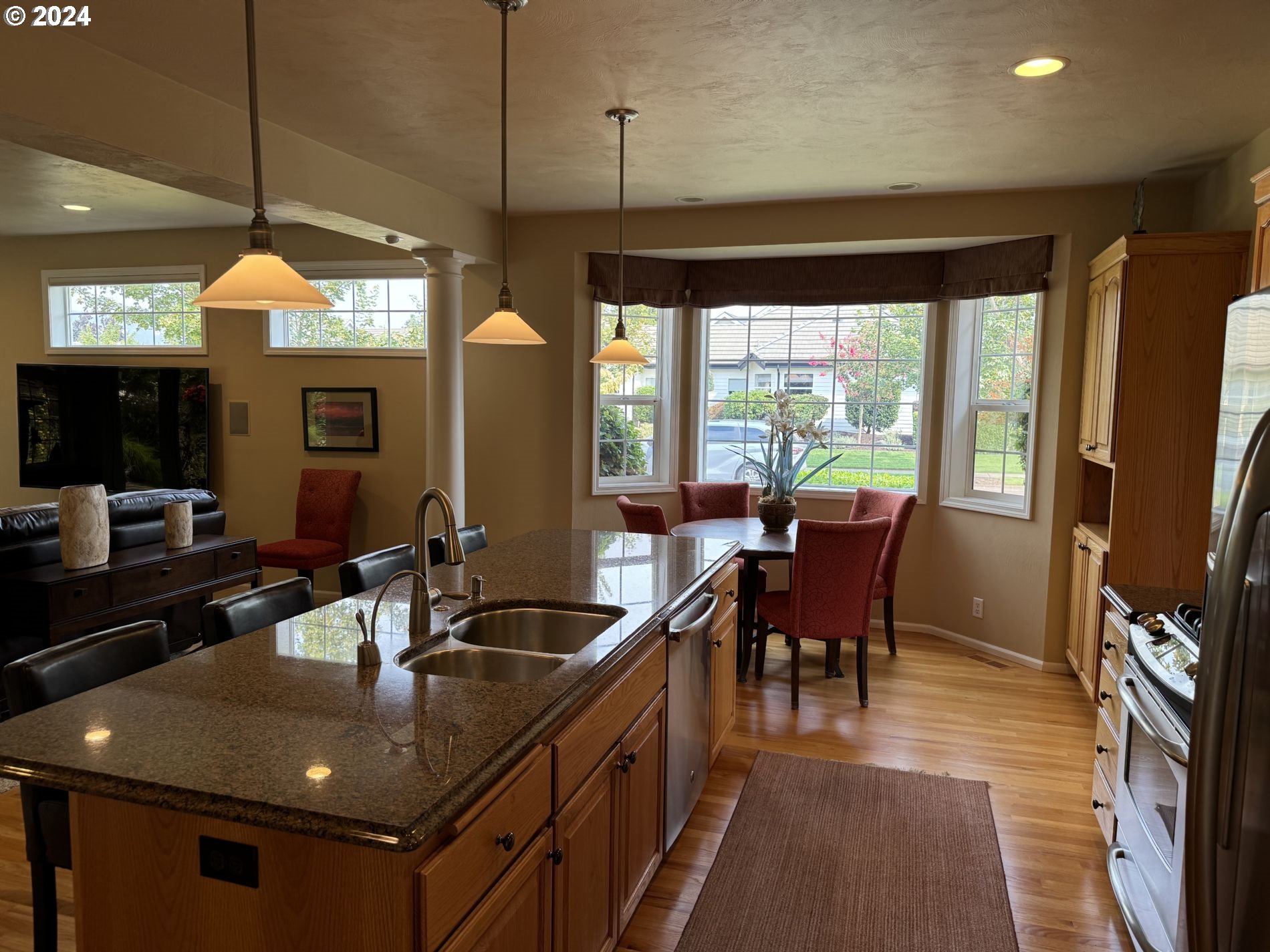 990 Old Orchard Lane Springfield, OR 97477 - Photo 12 of 16 a kitchen with a sink dining table and chairs