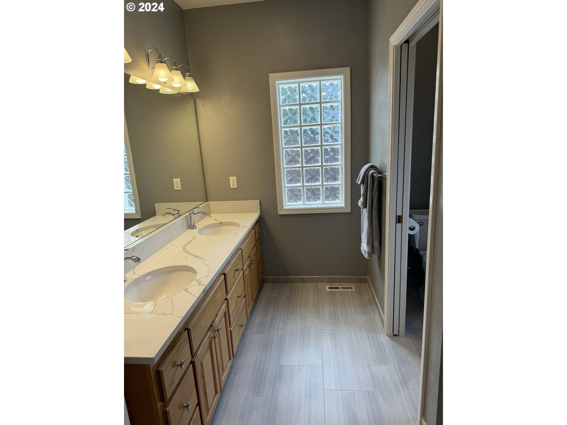 990 Old Orchard Lane Springfield, OR 97477 - Photo 16 of 16 a bathroom with a sink a vanity and a mirror