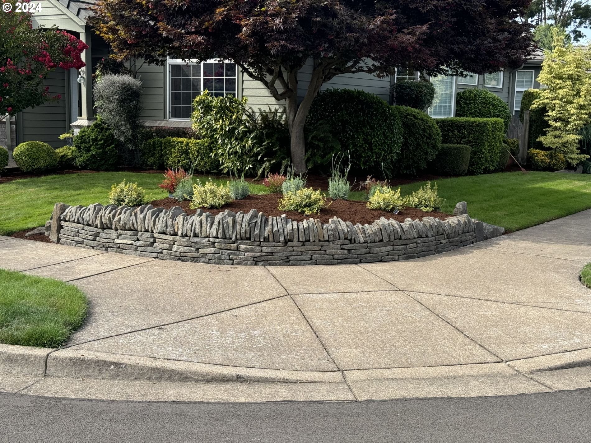 990 Old Orchard Lane Springfield, OR 97477 - Photo 3 of 16 a front view of a house with garden