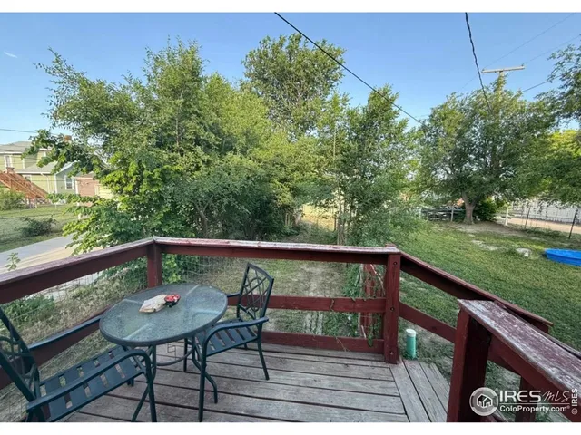 a view of a deck with a table and chairs
