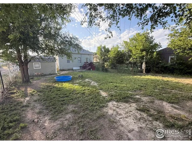 a view of a backyard with large trees