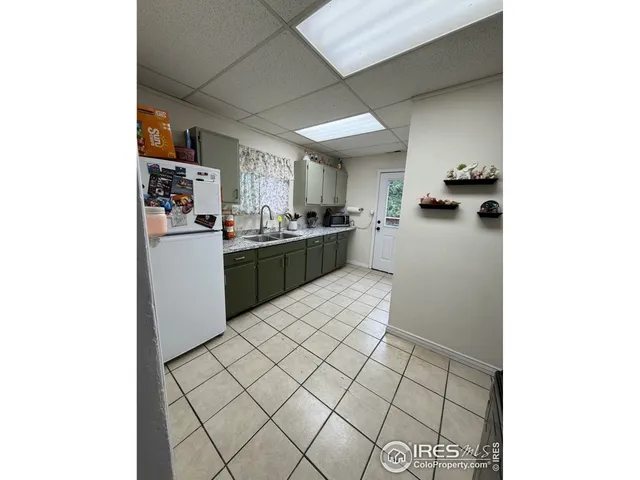 a kitchen with stainless steel appliances a refrigerator and a stove top oven