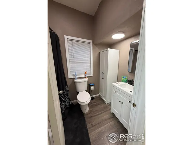 a bathroom with a toilet sink and a mirror
