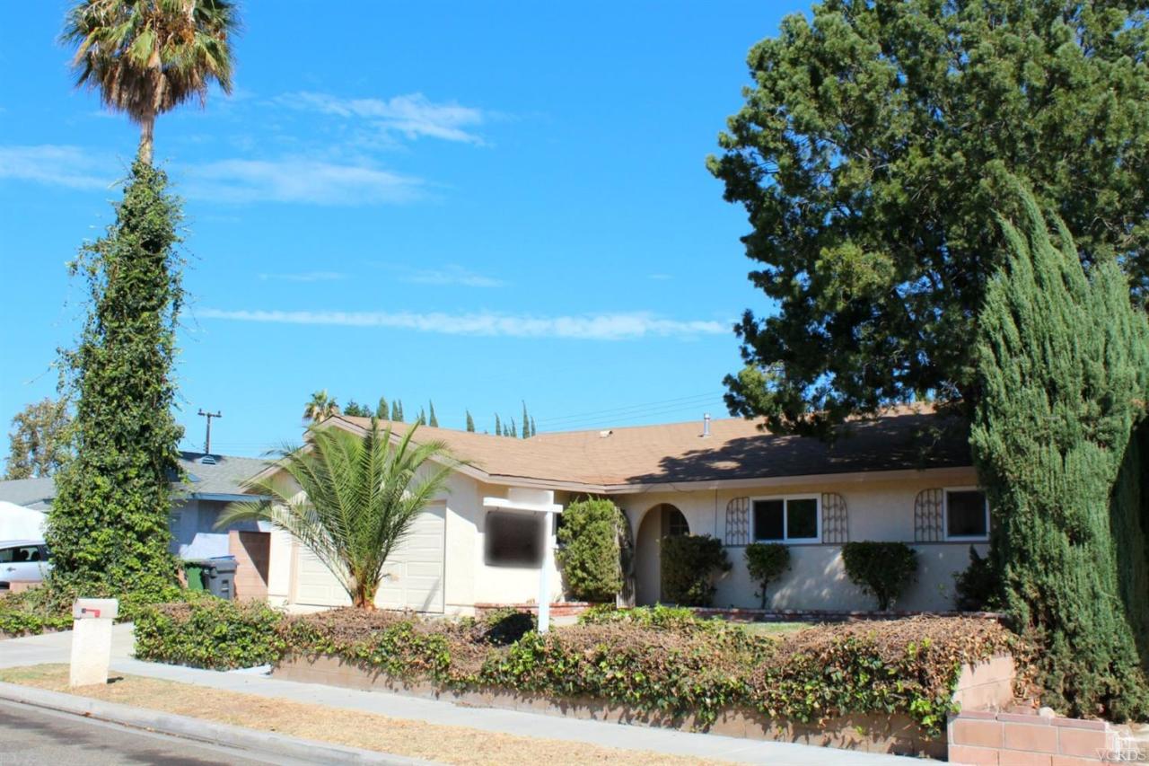 5317 Mildred Street Simi Valley, CA 93063 - Photo 16 of 16 a front view of a house with a yard and garage