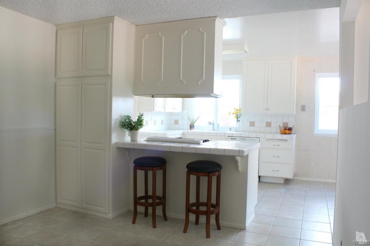 5317 Mildred Street Simi Valley, CA 93063 - Photo 3 of 16 a utility room with cabinets and chairs