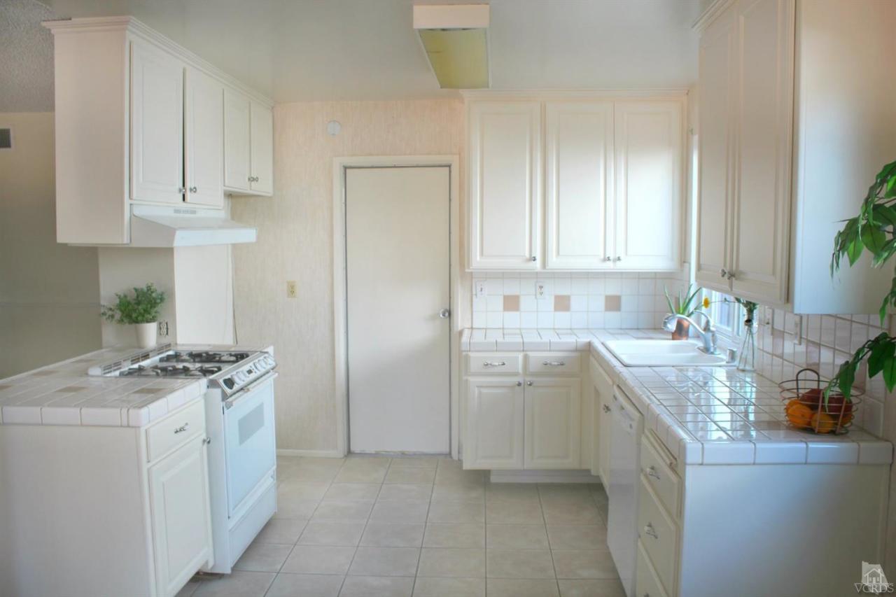 5317 Mildred Street Simi Valley, CA 93063 - Photo 5 of 16 a kitchen with stainless steel appliances granite countertop a sink stove and cabinets