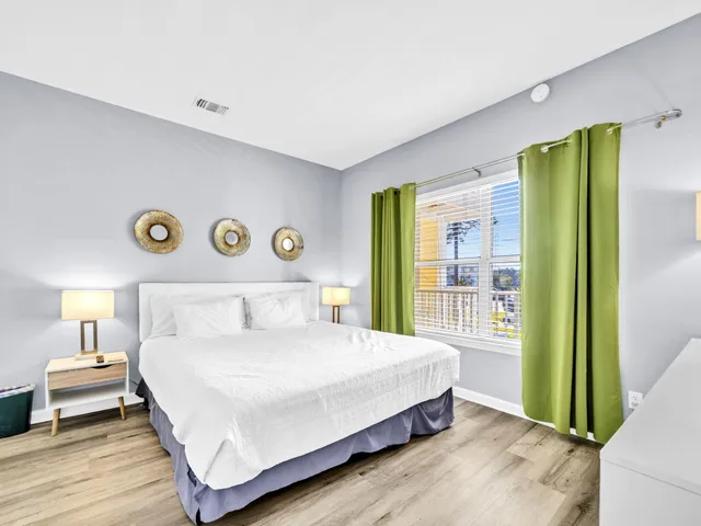 a bedroom with a bed and a large window