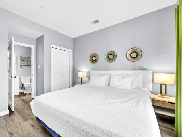 a bedroom with a bed and a lamp