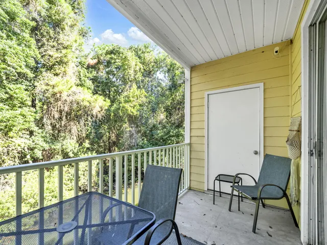 a view of a chair and table in the balcony
