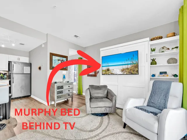 a living room with furniture and a ceiling fan