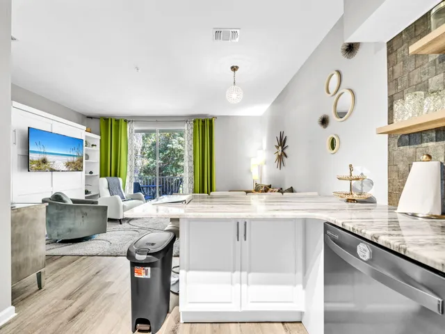 a living room with granite countertop furniture a fireplace and a large window
