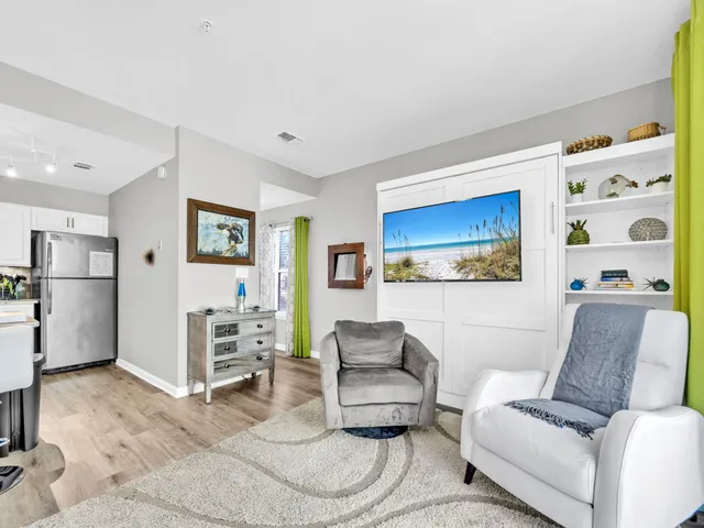 a living room with furniture and kitchen view