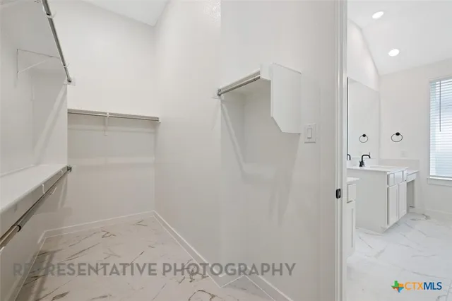 a bathroom with a shower and a sink